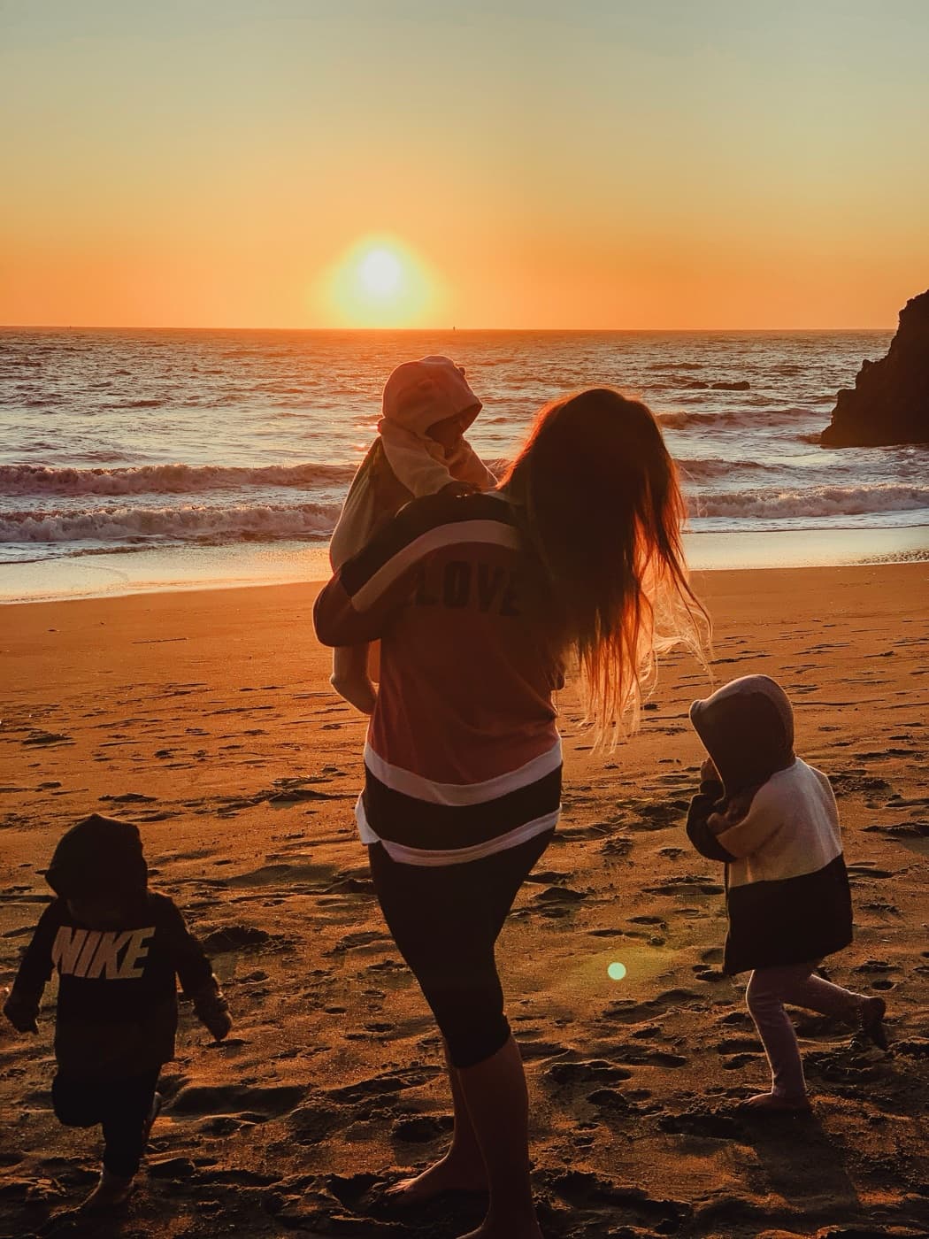 The photographer with her children at the beach at sunset