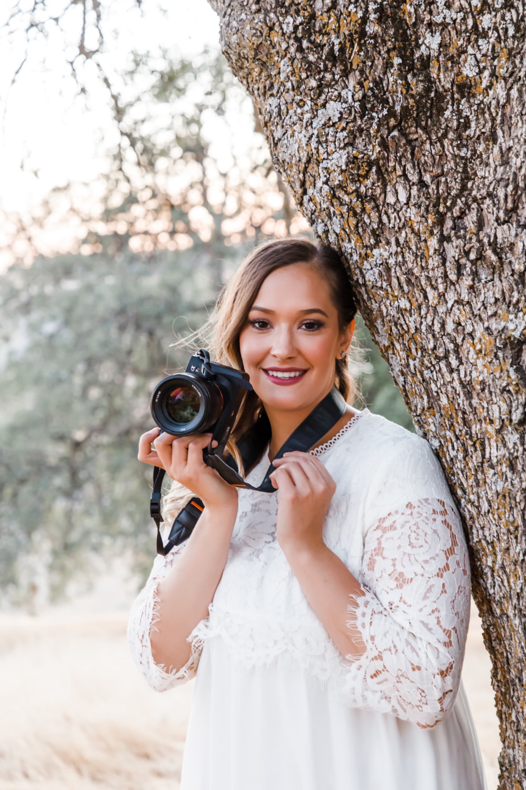 Portrait of the photographer behind Pine and Brook Photography, holding her camera