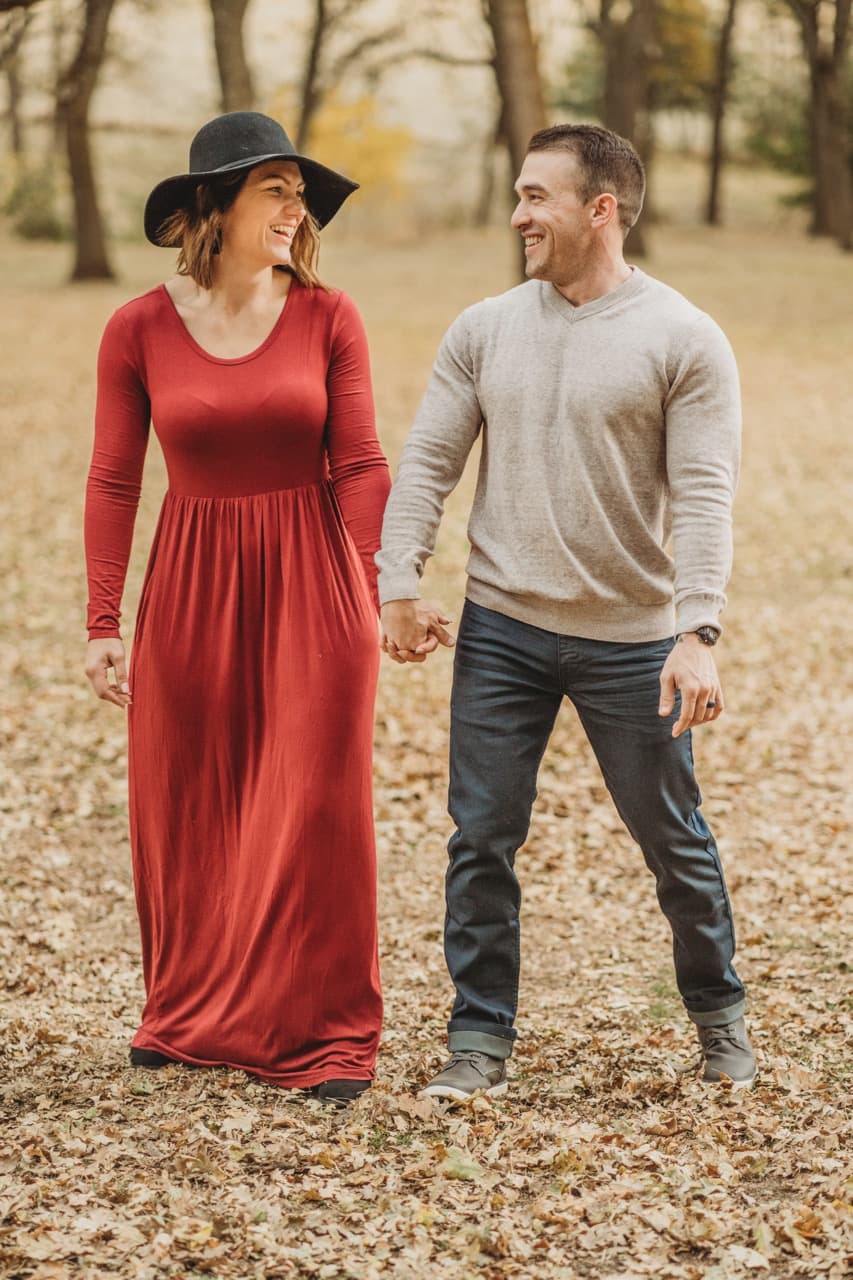 Couple in a shower of fall leaves