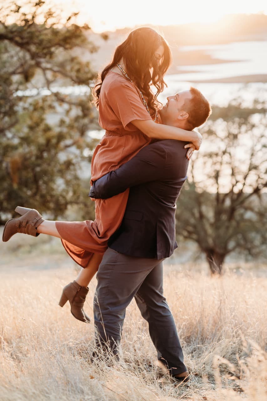 Couple lifted, dressed in rust tones